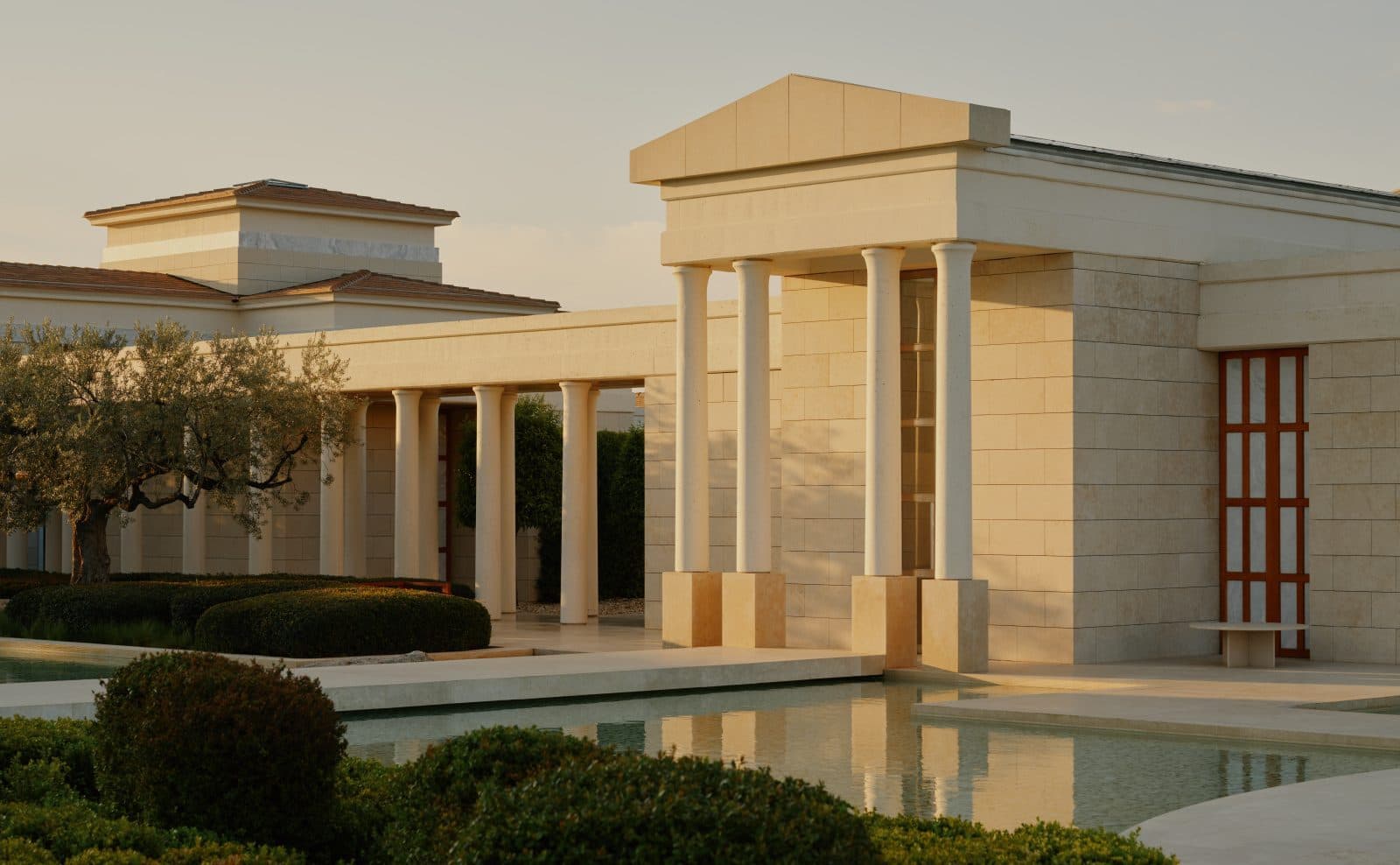 Amanzoe pavilions and pool at sunset