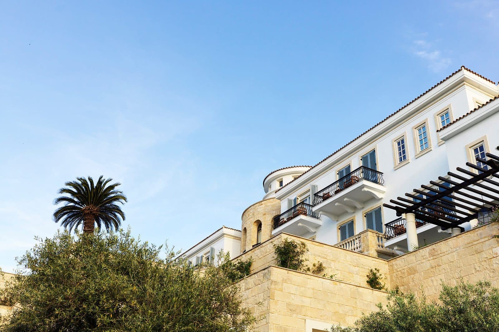Pale Anassa buildings among gardens