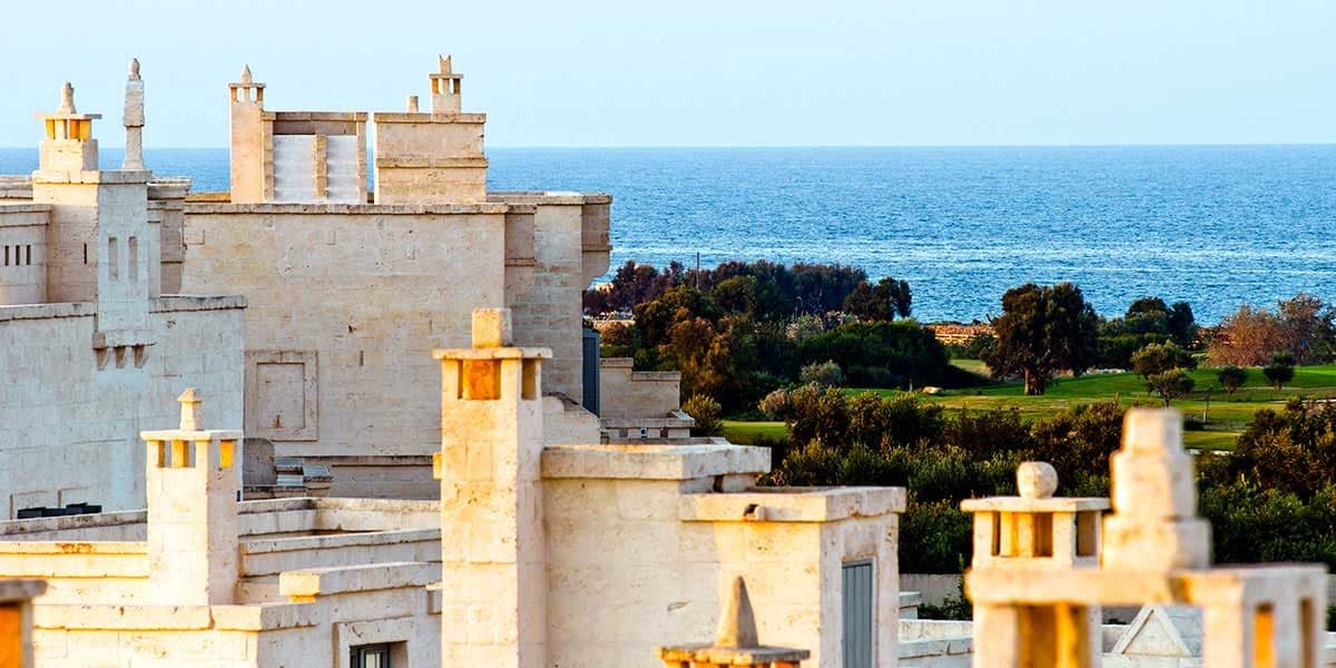 Pale Borgo Egnazia buildings above the coast