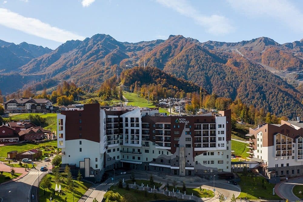 The Rosa Springs building in the Mountain Olympic Village against autumn mountains