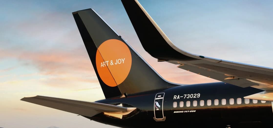 Lujo BlackJet tail with the orange Art & Joy emblem.